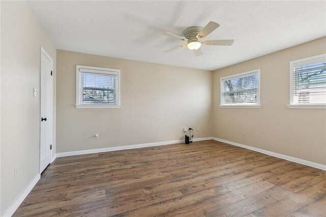 9408 Citrus Ln, River Ridge, LA 70123 - unfurnished room featuring healthy amount of natural light, wood finished floors, and a ceiling fan