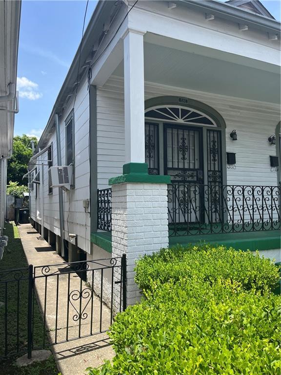 842426 Willow St, New Orleans, LA 70118 - doorway to property featuring a porch and cooling unit