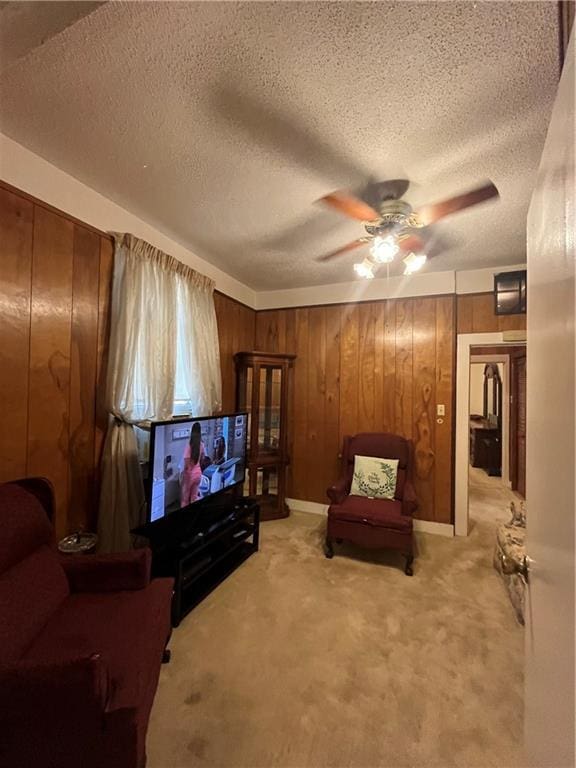 842426 Willow St, New Orleans, LA 70118 - living area featuring a ceiling fan, light carpet, a textured ceiling, and wooden walls