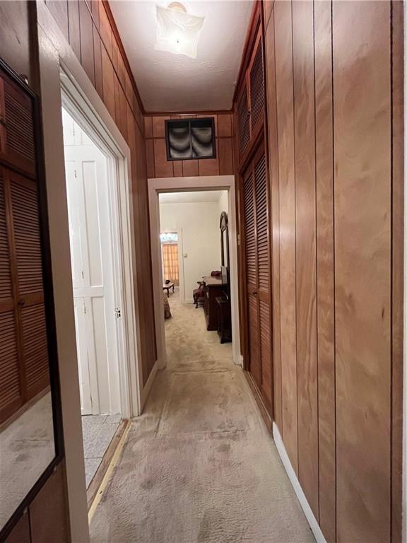 842426 Willow St, New Orleans, LA 70118 - hall featuring wooden walls and light colored carpet