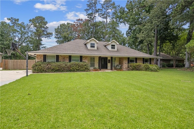 426 Devon Dr, Mandeville, LA 70448 - view of front of house featuring brick siding, covered porch, roof with shingles, and driveway