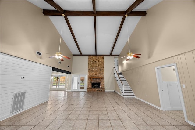 426 Devon Dr, Mandeville, LA 70448 - unfurnished living room with ceiling fan, high vaulted ceiling, a fireplace, beamed ceiling, and light tile patterned floors