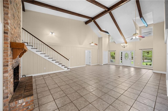 426 Devon Dr, Mandeville, LA 70448 - unfurnished living room with ceiling fan, tile patterned floors, high vaulted ceiling, beam ceiling, and a fireplace