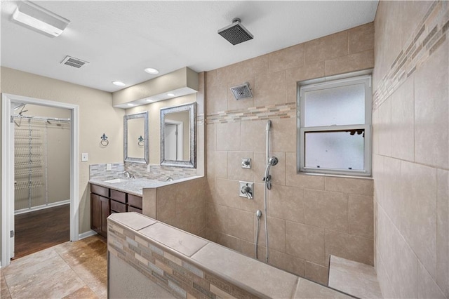 426 Devon Dr, Mandeville, LA 70448 - bathroom with a walk in shower, vanity, and a walk in closet