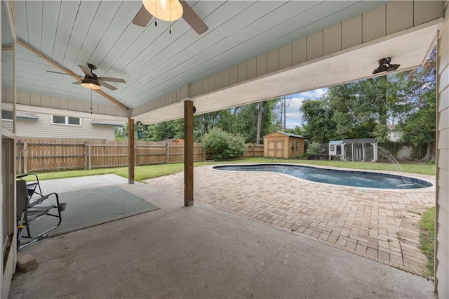 426 Devon Dr, Mandeville, LA 70448 - view of swimming pool with ceiling fan, a storage shed, a fenced backyard, and a patio area