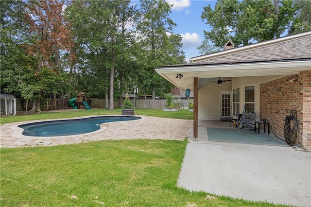 426 Devon Dr, Mandeville, LA 70448 - view of swimming pool with a ceiling fan, a playground, a fenced backyard, and a patio area