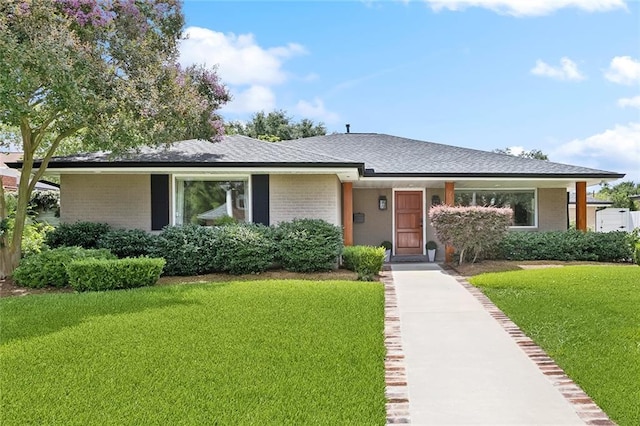 7320 General Haig St, New Orleans, LA 70124 - view of front of home with brick siding, a front yard, and a shingled roof
