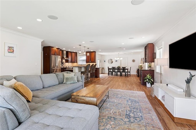7320 General Haig St, New Orleans, LA 70124 - living room featuring light wood-style floors, recessed lighting, and crown molding