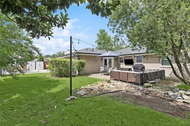 7320 General Haig St, New Orleans, LA 70124 - back of house with an outdoor living space, brick siding, a patio area, and a lawn