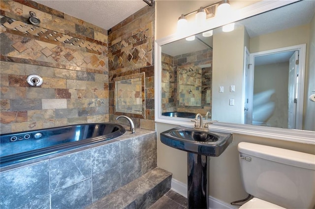 2808 Transcontinental Dr, Metairie, LA 70006 - bathroom featuring a garden tub and a textured ceiling