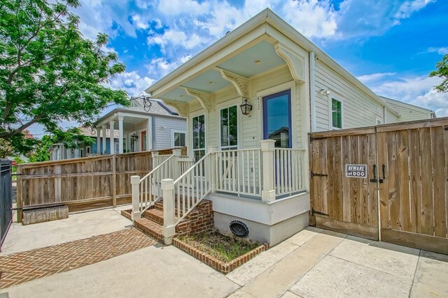 412 N Miro St, New Orleans, LA 70119 - view of front facade with a gate and a patio area