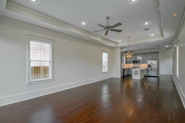 412 N Miro St, New Orleans, LA 70119 - unfurnished living room featuring a tray ceiling, dark wood-style flooring, a ceiling fan, crown molding, and recessed lighting