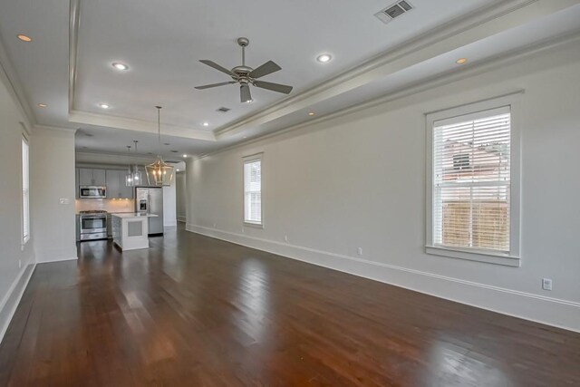 412 N Miro St, New Orleans, LA 70119 - unfurnished living room featuring a raised ceiling, dark wood-style flooring, a ceiling fan, ornamental molding, and recessed lighting