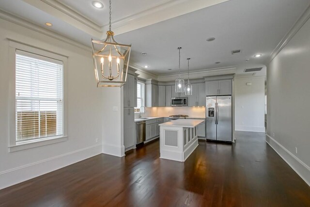 412 N Miro St, New Orleans, LA 70119 - kitchen featuring stainless steel appliances, crown molding, gray cabinets, a chandelier, and light countertops