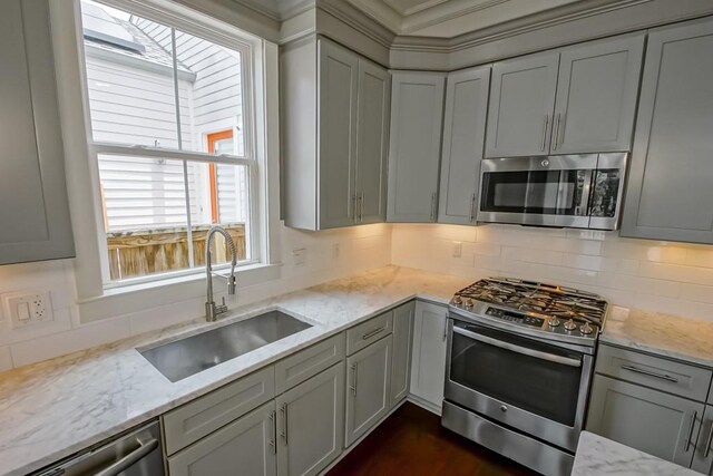 412 N Miro St, New Orleans, LA 70119 - kitchen with appliances with stainless steel finishes, decorative backsplash, and light stone countertops