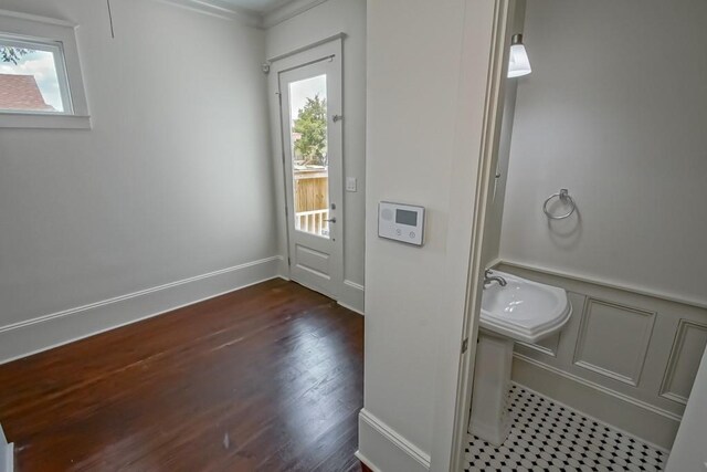 412 N Miro St, New Orleans, LA 70119 - bathroom with plenty of natural light, wood finished floors, a wainscoted wall, and a decorative wall