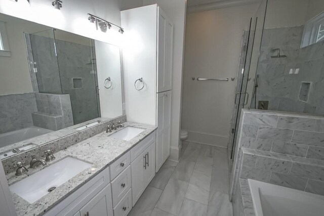 412 N Miro St, New Orleans, LA 70119 - bathroom featuring marble look tiles, a bath, a shower stall, and double vanity