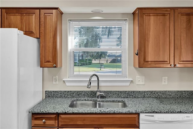147 Jesuit Bend Dr, Belle Chasse, LA 70037 - kitchen with white appliances, brown cabinetry, and light stone countertops