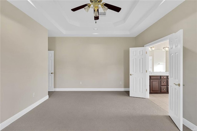 147 Jesuit Bend Dr, Belle Chasse, LA 70037 - empty room with light carpet, a ceiling fan, and a raised ceiling