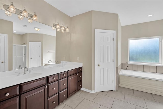 147 Jesuit Bend Dr, Belle Chasse, LA 70037 - bathroom featuring a garden tub, double vanity, a stall shower, and tile patterned floors