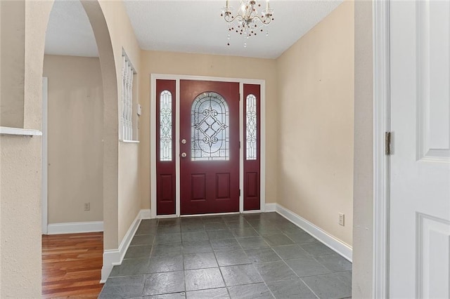 3632 N Hullen St, Metairie, LA 70002 - entryway with arched walkways and a chandelier