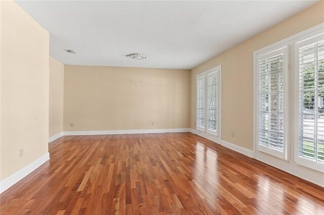 3632 N Hullen St, Metairie, LA 70002 - spare room featuring hardwood / wood-style flooring and plenty of natural light