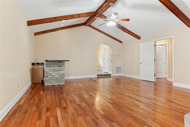 3632 N Hullen St, Metairie, LA 70002 - unfurnished living room with arched walkways, ceiling fan, and light wood-style floors