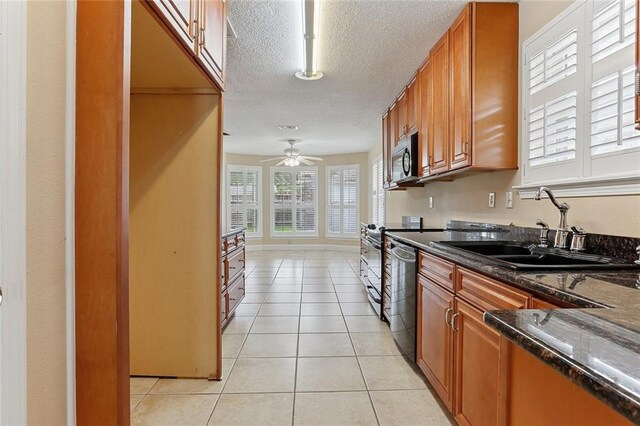 3632 N Hullen St, Metairie, LA 70002 - kitchen featuring brown cabinetry, a textured ceiling, light tile patterned floors, ceiling fan, and stainless steel appliances