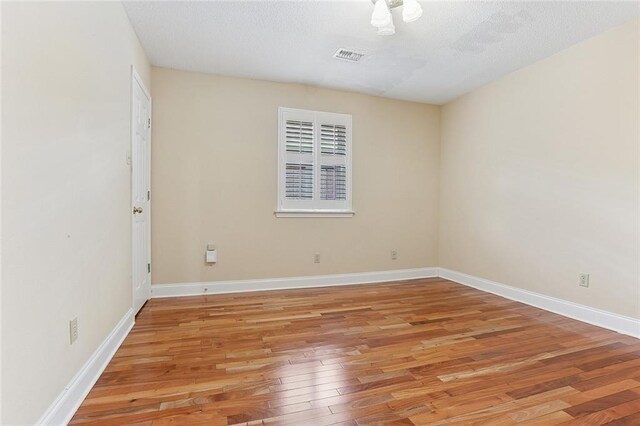 3632 N Hullen St, Metairie, LA 70002 - empty room featuring light wood-style flooring and a textured ceiling