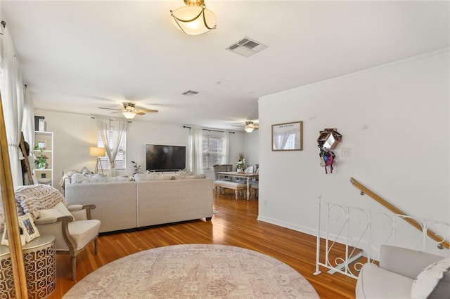 665254 General Diaz St, New Orleans, LA 70124 - living room featuring ceiling fan, wood finished floors, and ornamental molding