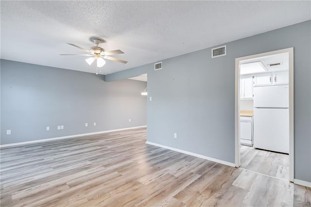 101 Wilbourn Blvd Unit 102, Lafayette, LA 70506 - empty room featuring a ceiling fan, light wood-style flooring, and a textured ceiling
