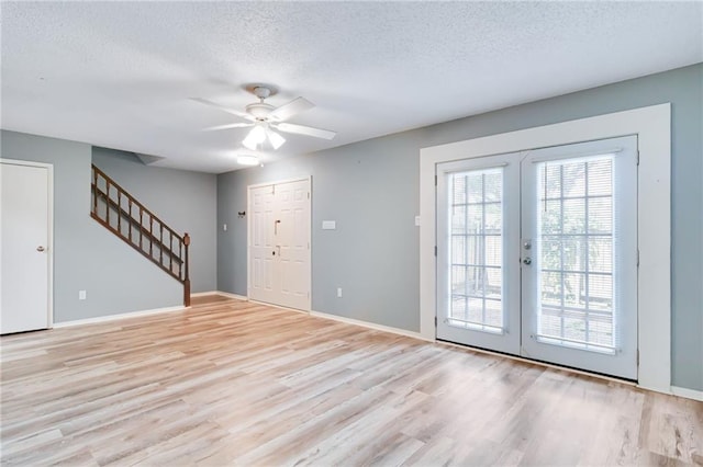 101 Wilbourn Blvd Unit 102, Lafayette, LA 70506 - foyer featuring plenty of natural light, stairway, a textured ceiling, light wood finished floors, and ceiling fan