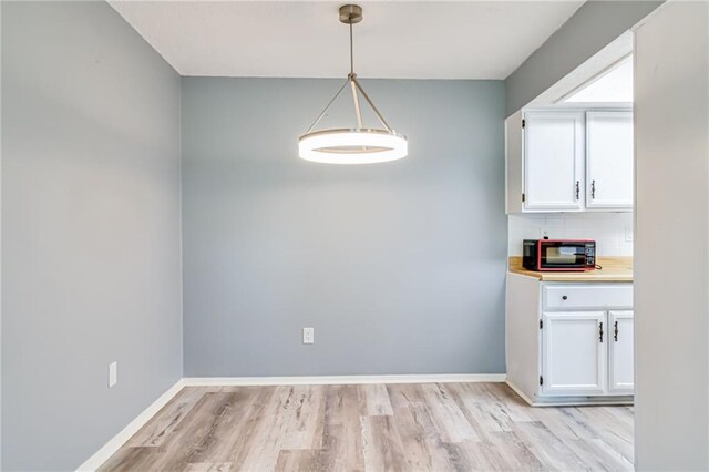 101 Wilbourn Blvd Unit 102, Lafayette, LA 70506 - unfurnished dining area with light wood-style floors and baseboards