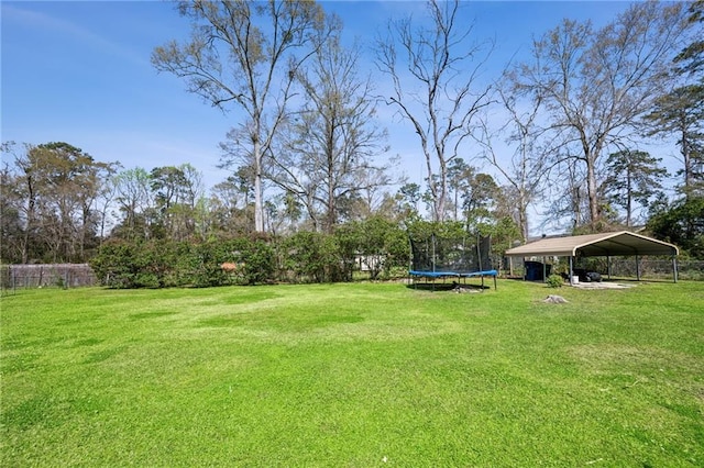 912 W 25th Ave, Covington, LA 70433 - view of yard with a trampoline and a carport
