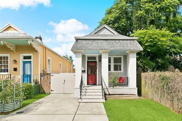 8426 Green St, New Orleans, LA 70118 - shotgun-style home featuring a gate and covered porch