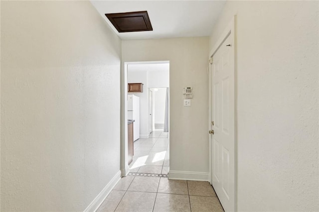 8426 Green St, New Orleans, LA 70118 - hall featuring light tile patterned floors and attic access