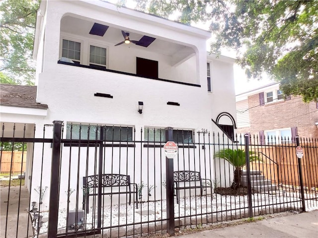 21416 N 12th St, Baton Rouge, LA 70802 - view of front facade featuring stucco siding, a fenced front yard, and a ceiling fan