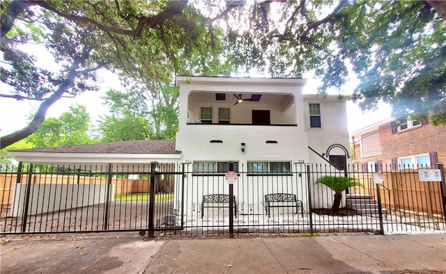 21416 N 12th St, Baton Rouge, LA 70802 - view of front of home featuring stucco siding, a fenced front yard, and a balcony