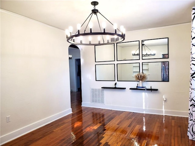 21416 N 12th St, Baton Rouge, LA 70802 - unfurnished dining area featuring a chandelier, arched walkways, crown molding, and wood-type flooring