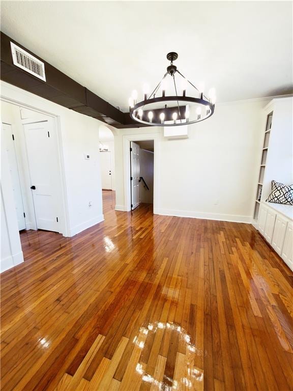 21416 N 12th St, Baton Rouge, LA 70802 - unfurnished dining area featuring a chandelier, wood-type flooring, and arched walkways