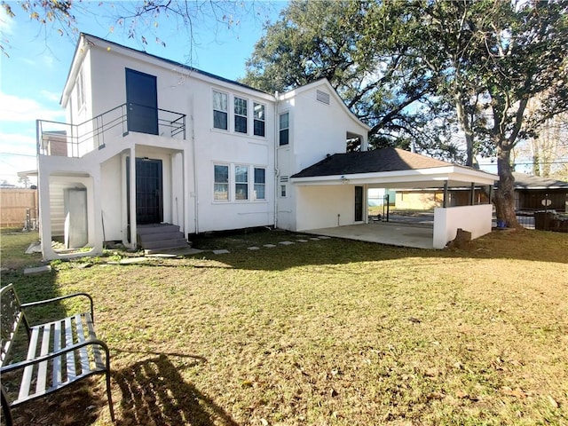 21416 N 12th St, Baton Rouge, LA 70802 - rear view of property with stucco siding, a balcony, and a yard