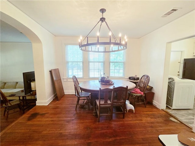 21416 N 12th St, Baton Rouge, LA 70802 - dining space with wood finished floors, arched walkways, washer / dryer, and a chandelier