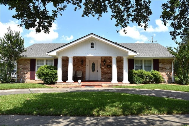 5501 Chatham Dr, New Orleans, LA 70122 - greek revival inspired property featuring brick siding, a front yard, and a porch