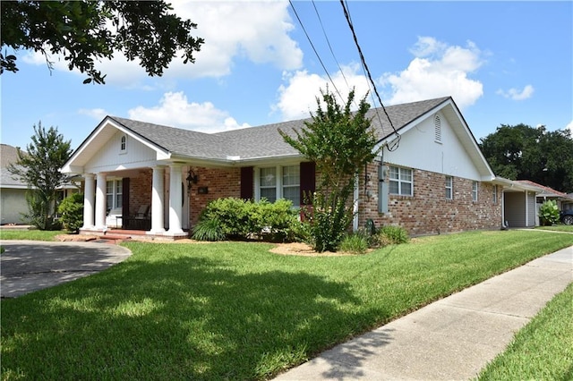 5501 Chatham Dr, New Orleans, LA 70122 - view of front of house featuring brick siding, covered porch, a front yard, and a shingled roof