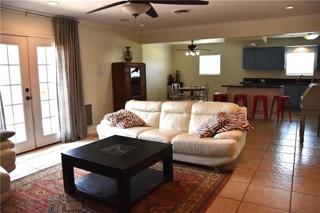 5501 Chatham Dr, New Orleans, LA 70112 - living area featuring ceiling fan, light tile patterned floors, ornamental molding, and french doors