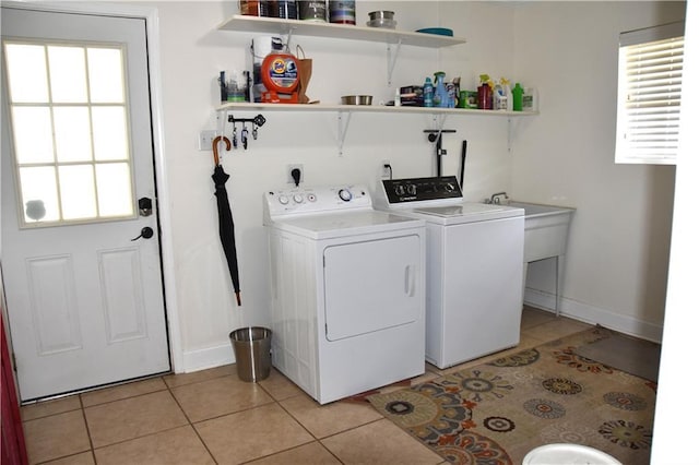 5501 Chatham Dr, New Orleans, LA 70112 - laundry room with washer and clothes dryer and light tile patterned floors