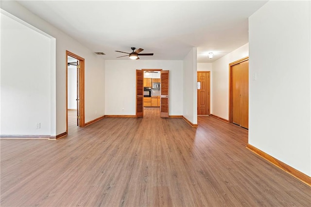 1709 Francis Ave, Metairie, LA 70003 - unfurnished living room featuring ceiling fan and light wood finished floors