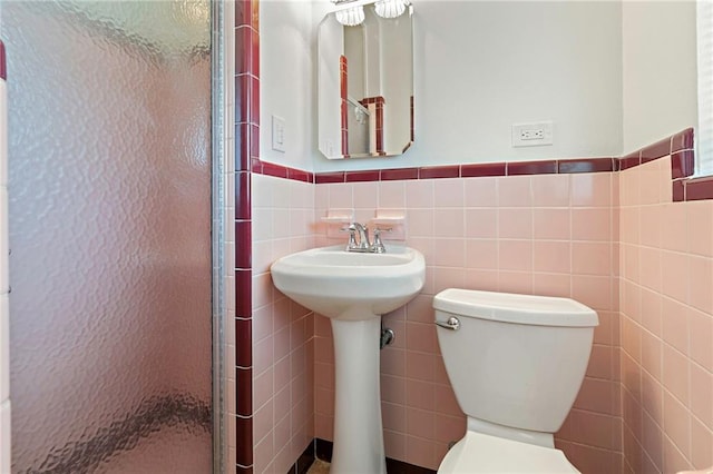 1709 Francis Ave, Metairie, LA 70003 - bathroom with a shower stall, tile walls, and a wainscoted wall
