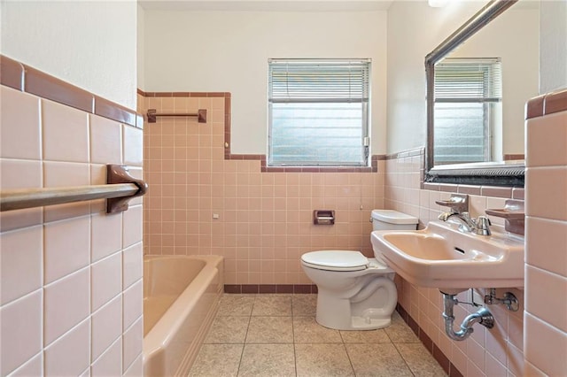 1709 Francis Ave, Metairie, LA 70003 - full bath with tile walls, a tub, tile patterned floors, and wainscoting