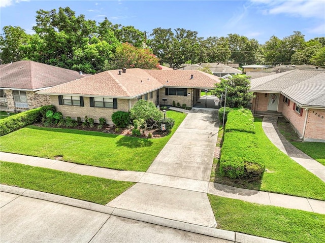 1709 Francis Ave, Metairie, LA 70003 - view of front of house featuring concrete driveway, a front yard, brick siding, and a carport